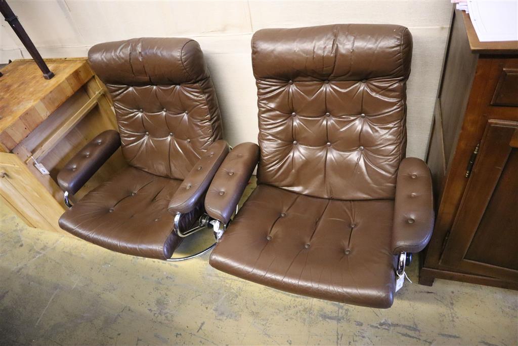 A pair of Erkones brown leather and chrome reclining armchairs